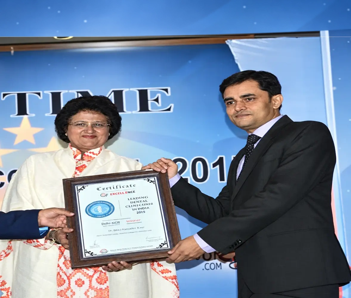 Dental Samagra receiving a certificate of excellence in dentistry